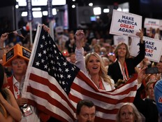 An attendee hold an American flag at the end of the fourth day of the Republican National Convention at the Fiserv Forum on July 18, 2024 in Milwaukee, Wisconsin.
