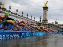 Athletes compete in the Olympic triathlon race in the Seine during the women's individual triathlon at the Paris 2024 Olympic Games.