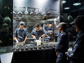 Staff members of Ultraviolet restaurant work inside the kitchen as they prepare for their guests in Shanghai