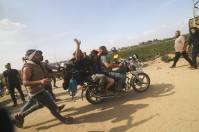 Palestinians transport a captured Israeli civilian