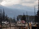 Fire crews work in a devastated neighbourhood in Jasper, Alta., on Friday, July 26, 2024.