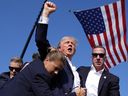 Republican presidential candidate former President Donald Trump is surrounded by U.S. Secret Service agents at a campaign rally, Saturday, July 13, 2024, in Butler, Pa.