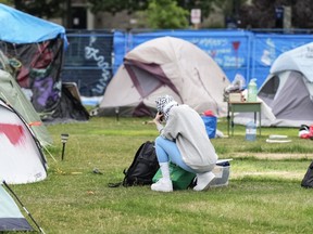 A protester is seen in the pro-Palestinian encampment at the University of Toronto, on Tuesday, July 2, 2024. The Toronto Police Service says it will enforce a court order granted yesterday that says demonstrators at a pro-Palestinian protest encampment at the University of Toronto must dismantle the site by 6 p.m. today.