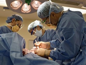 FILE - Surgeons perform a bilateral mastectomy on a transgender patient at a hospital in Boston on Friday, July 15, 2016. On Wednesday, July 3, 2024, a U.S. federal district court judge temporarily halted parts of a nondiscrimination rule that would have kept insurers and medical professionals from denying hormone therapy, gender transition surgeries and similar medical care for transgender people.
