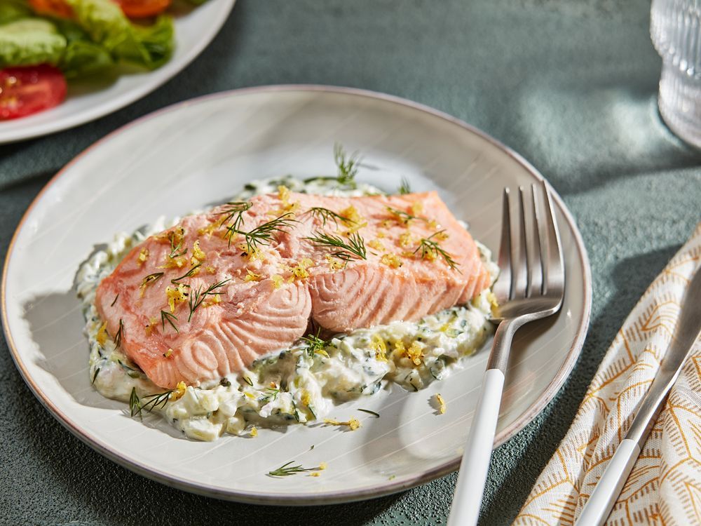 NextImg:Poached salmon with zucchini tzatziki is an easy but impressive dish