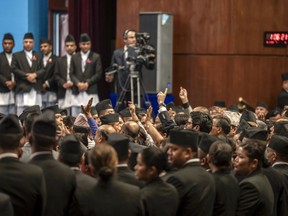 FILE- Opposition party members try to obstruct the proceedings of a vote of confidence on Prime Minister Pushpa Kamal Dahal in Kathmandu, Nepal, May 20, 2024.