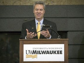 FILE - In this image provided by University of Wisconsin-Milwaukee, Mark Mone speaks at a press conference in the student union at the University of Wisconsin-Milwaukee on Monday, Dec. 15, 2014 in Milwaukee, Wis. University of Wisconsin-Milwaukee Chancellor Mark Mone announced Wednesday, July 3, 2204, that he plans to step down next year and transition to a teaching role as the UW system continues to struggle financially.