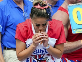 Miki Sudo competes in the Nathan's Famous Fourth of July hot dog eating contest, Thursday, July 4, 2024, at Coney Island in the Brooklyn borough of New York. Sudo ate a record 51 hot dogs.
