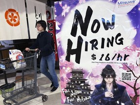 A hiring sign is displayed at a restaurant in Arlington Heights, Ill., Friday, June 28, 2024. On Tuesday, July 2, 2024, the Labor Department reports on job openings and labor turnover for May.