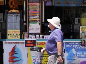 FILE - A person walks past an ice cream stand on the boardwalk, Thursday, June 2, 2022, in Ocean City, N.J. A type of bankruptcy protection filing that made it easier for small businesses to seek relief has expired, which will complicate filing for small businesses with more than $3 million in debt.