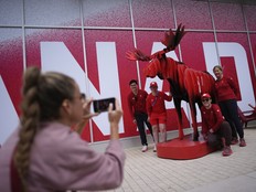Members of Canada's shooting team pose with a moose outside Canada's residence in the Olympic Village, at the 2024 Summer Olympics