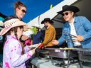 Federal Conservative leader Pierre Poilievre serves guests at the Makami College Stampede breakfast on Saturday July 6, 2024.