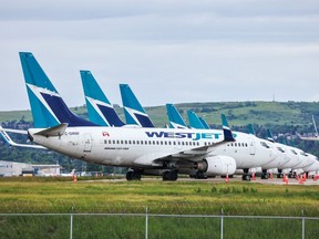 Over twenty WestJet planes parked at the Calgary International Airport await being brought back into service following the end of the WestJet mechanics strike on Monday July 1, 2024.