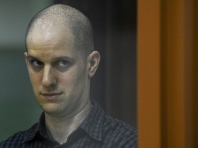 Wall Street Journal reporter Evan Gershkovich stands in a glass cage in a courtroom in Yekaterinburg, Russia, Wednesday, June 26, 2024. Fifteen months after he was arrested in the city of Yekaterinburg on espionage charges, Gershkovich returns there for his trial starting Wednesday, June 26, 2024, behind closed doors. Gershkovich, his employer and the U.S. government deny the charges. (AP Photo)