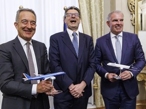 From left, ITA President Angelo Turicchi, Italian Economy Minister Giancarlo Giorgetti, and Lufthansa's CEO Carsten Spohr pose for a photo after a press conference where they explained the Lufthansa - ITA deal in Rome, Wednesday, July 3, 2024.