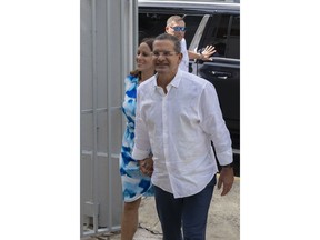 Gov. Pedro Pierluisi and his fiancee Fabiola Ansotegui Blanc arrive at a polling station to vote in the gubernatorial primaries, in San Juan, Puerto Rico, Sunday, June 2, 2024.