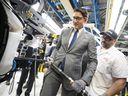 Justin Trudeau tightens bolts as he installs the front end assembly of a Honda CRV at Honda's manufacturing plant in Alliston, Ontario, on April 25. The federal and provincial governments are subsidizing a new Honda electric vehicle battery plant. (Photo credit: PETER POWER/AFP via Getty Images)