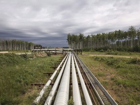 A Suncor pipeline carries various liquids from the Mackay River platform in the Alta oil sands region in Fort McMurray on Monday, June 12, 2017.