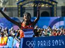 Netherlands' gold medallist Sifan Hassan crosses the finish in first place in the women's marathon of the athletics event at the Paris 2024 Olympic Games at The Invalides in Paris on August 11, 2024.
