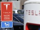 This photograph shows a sign indicating a parking for Tesla Electric vehicles, in Nivelles, on August 26, 2024. (Photo by ERIC LALMAND / Belga / AFP)