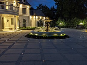 Tiered fountains command attention in the centre of a circular driveway.