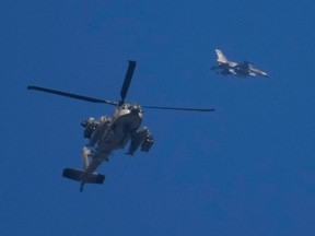 A helicopter, a fighter jet and the blue sky.