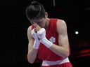 Taiwan's Lin Yu-ting reacts after defeating Uzbekistan's Sitora Turdibekova in their women's 57 kg preliminary boxing match at the Olympics.
