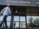 Lawyers for two men convicted of mischief at the 2022 border blockade at Coutts, Alta., are scheduled to appear in court Monday to determine next steps in sentencing. A man enters the courthouse in Lethbridge, Friday, Aug. 2, 2024.