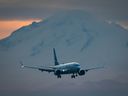 Mount Baker in Washington is seen in the distance as a WestJet Airlines Boeing 737 Max aircraft arrives at Vancouver International Airport. A flight in April 2023 was diverted to Victoria due to smoke from a volcano.
