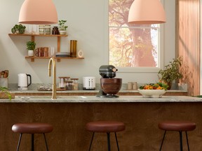 KitchenAid’s Artisan Design Series Evergreen 5-Quart Tilt-Head Stand Mixer has a forest-green stand with a walnut-wood bowl, a stunning spin on silver.