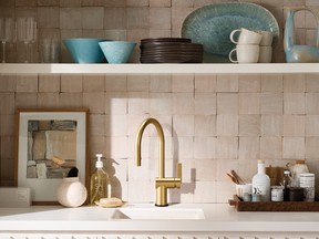 Moen’s Cia gold faucet can be paired with a black escutcheon plate.