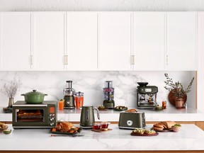 Olive-toned appliances accessorize a white kitchen.