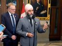 Jagmeet Singh, with NDP MP Peter Julian, speaks with reporters in the foyer of the House of Commons, Thursday, September 19, 2024