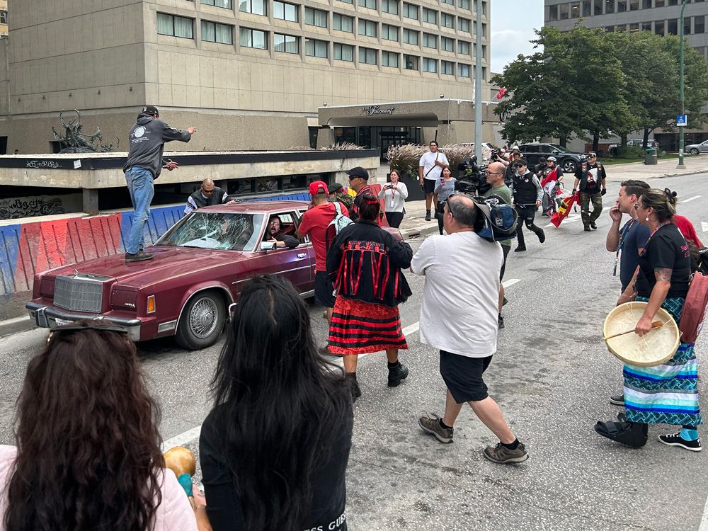 NextImg:Driver confronted as car driven through protest against police in Winnipeg