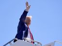 Republican presidential nominee former President Donald Trump waves as he boards a plane at Harry Reid International Airport after a campaign trip, Saturday, Sept.14, 2024, in Las Vegas.