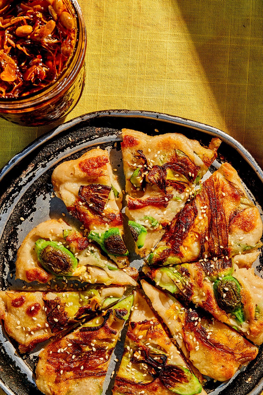 Smoked fish and squash blossom pancake with crispy honey chili oil