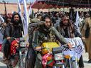 Taliban security personnel holding rocket-propelled grenade ride motorbikes as they celebrate the third anniversary of Taliban takeover of Afghanistan in Khost on August 14, 2024.