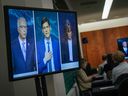 Politics tamfitronics B.C. Conservative Leader John Rustad, from left to right, B.C. NDP Leader David Eby and B.C. Green Party Leader Sonia Furstenau are seen on television screens as reporters watch the televised leaders' debate, in Vancouver, on Tuesday, October 8, 2024.