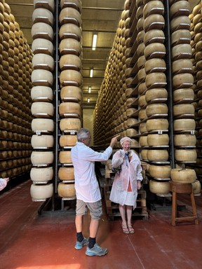 Learning about the history and cheese making process in a family-owned Parmigiano Reggiano caseifico in Parma.