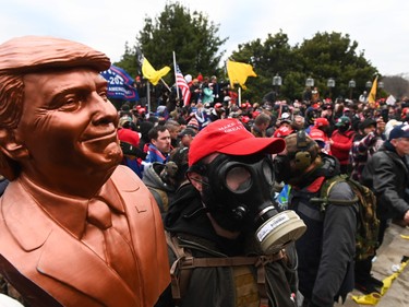 Jan. 6 insurrectionists carrying a bust of Trump