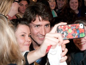 Justin Trudeau taking photos with supporters.