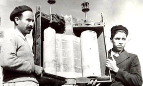 Two men holding a scroll.