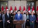 Prime Minister Justin Trudeau and Immigration, Refugees and Citizenship Minister Marc Miller are joined by fellow members of Parliament as they hold a press conference on Parliament Hill in Ottawa on Thursday, Oct. 24, 2024.