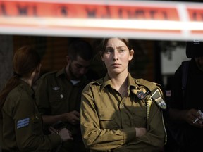 An Israeli soldier looks at the scene