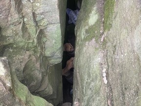 Woman retrieving phone in crevice gets stuck for 7 hours upside-down Woman retrieving phone in crevice gets stuck for 7 hours upside-down