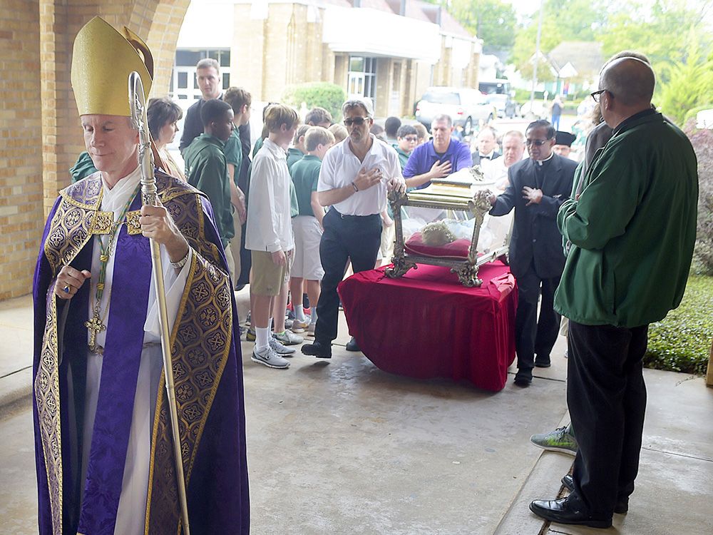Bishop Joseph Strickland walks in front of a reliquary bearing the bones of Saint Maria Goretti at Cathedral of the Immaculate Conception in Tyler, Texas, in November 2015.