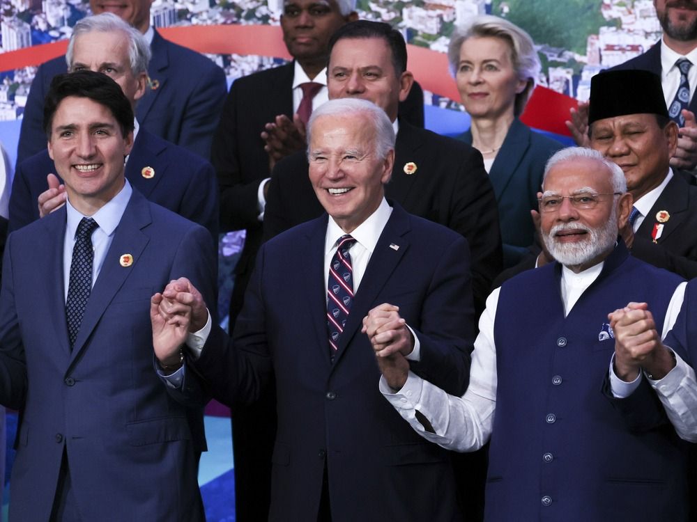 Justin Trudeau, Joe Biden and Narendra Modi link hands for a group photo during the G20 summit in Rio.