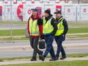 Canada Post workers walk the picket line in Mississauga, Ont., on Nov. 20.