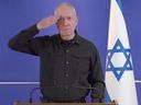 Outoing Israeli Minister of Defence Yoav Gallant salutes to Israel's fallen and injured soldiers and hostages and their families at the conclusion of a press conference after being fired by Prime Minister Benjamin Netanyahu.