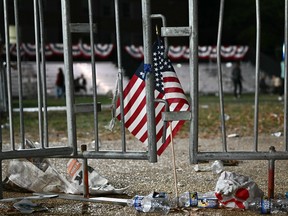 A flag, garbage and an empty field.